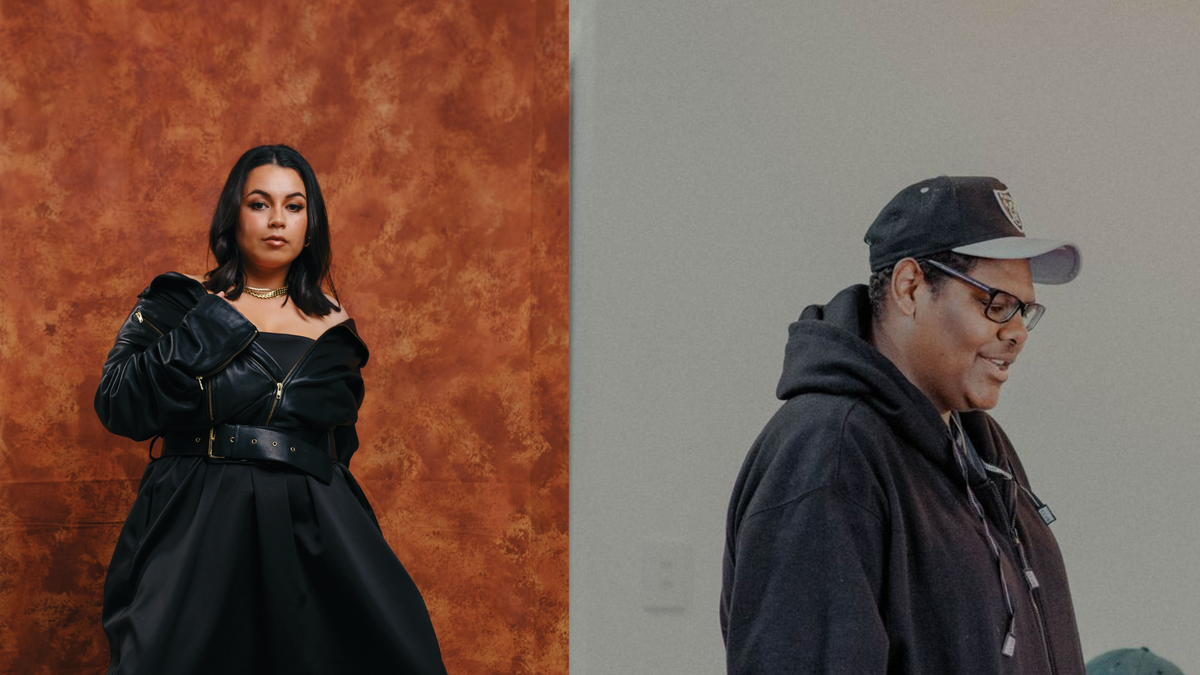 The image is split into two. On the left, a woman stands powerfully in front of an earthy brown, patterned wall. She looks directly at the camera with a strong, neutral expression. Her black, shiny skirt of her dress puffs outwards. The bodice of the dress is tighter and hidden underneath a black leather jacket, with gold zips. She also wears a black leather belt with gold belt holes. The jacket fits loosely and falls off the woman's shoulders, exposing a gold necklace around her neck. Her make-up is shiny and beautiful with glossy, long black hair. The man on the right stands in front of a plain grey background.