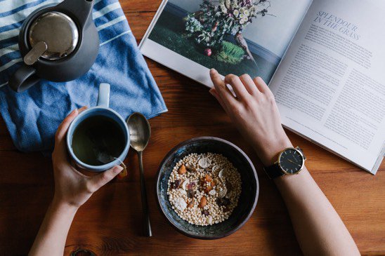 Reading a magazine with breakfast